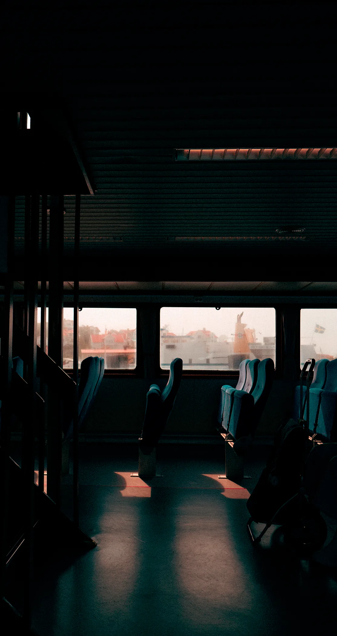 Sunlight falling across the empty seats of a ferry cabin