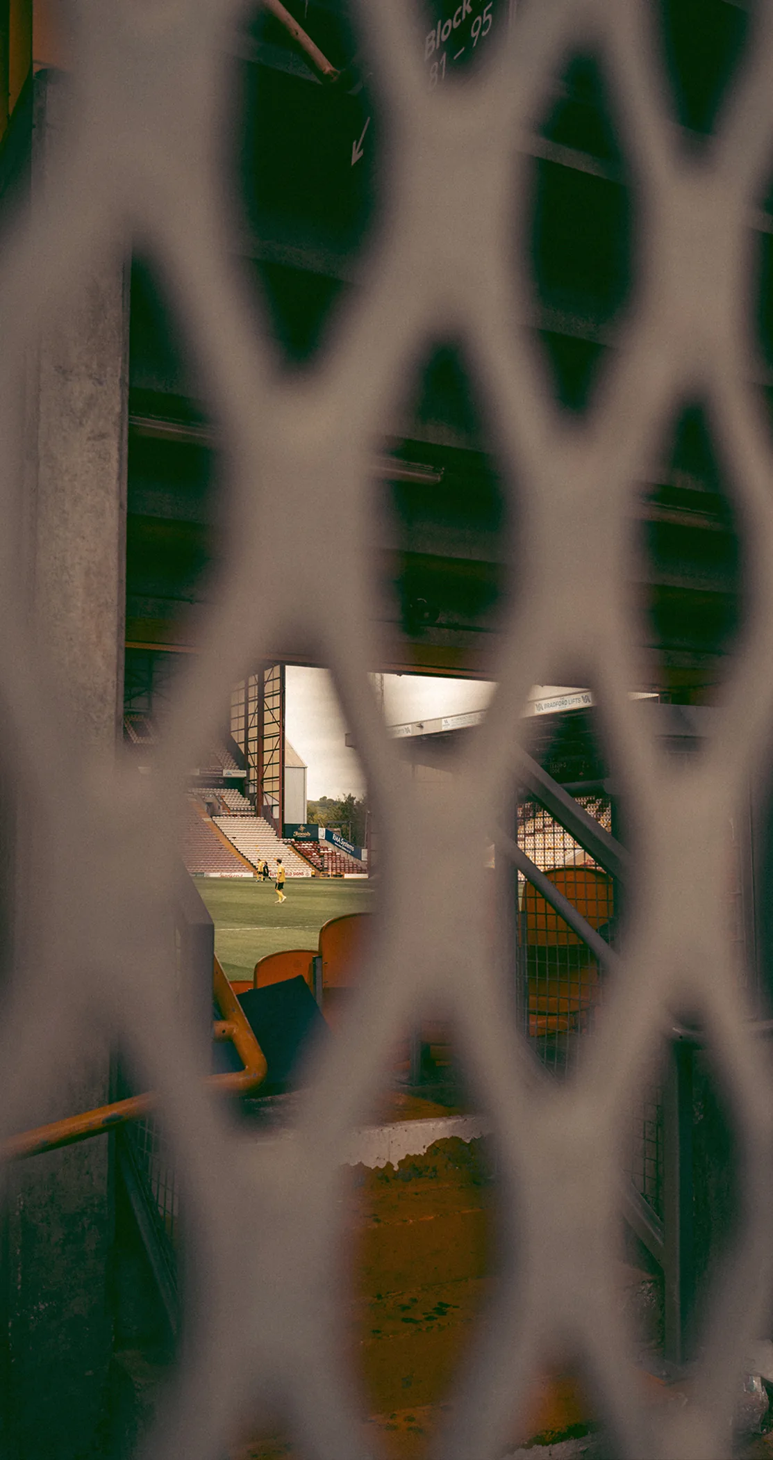 View through a green diamond mesh fence, Leeds