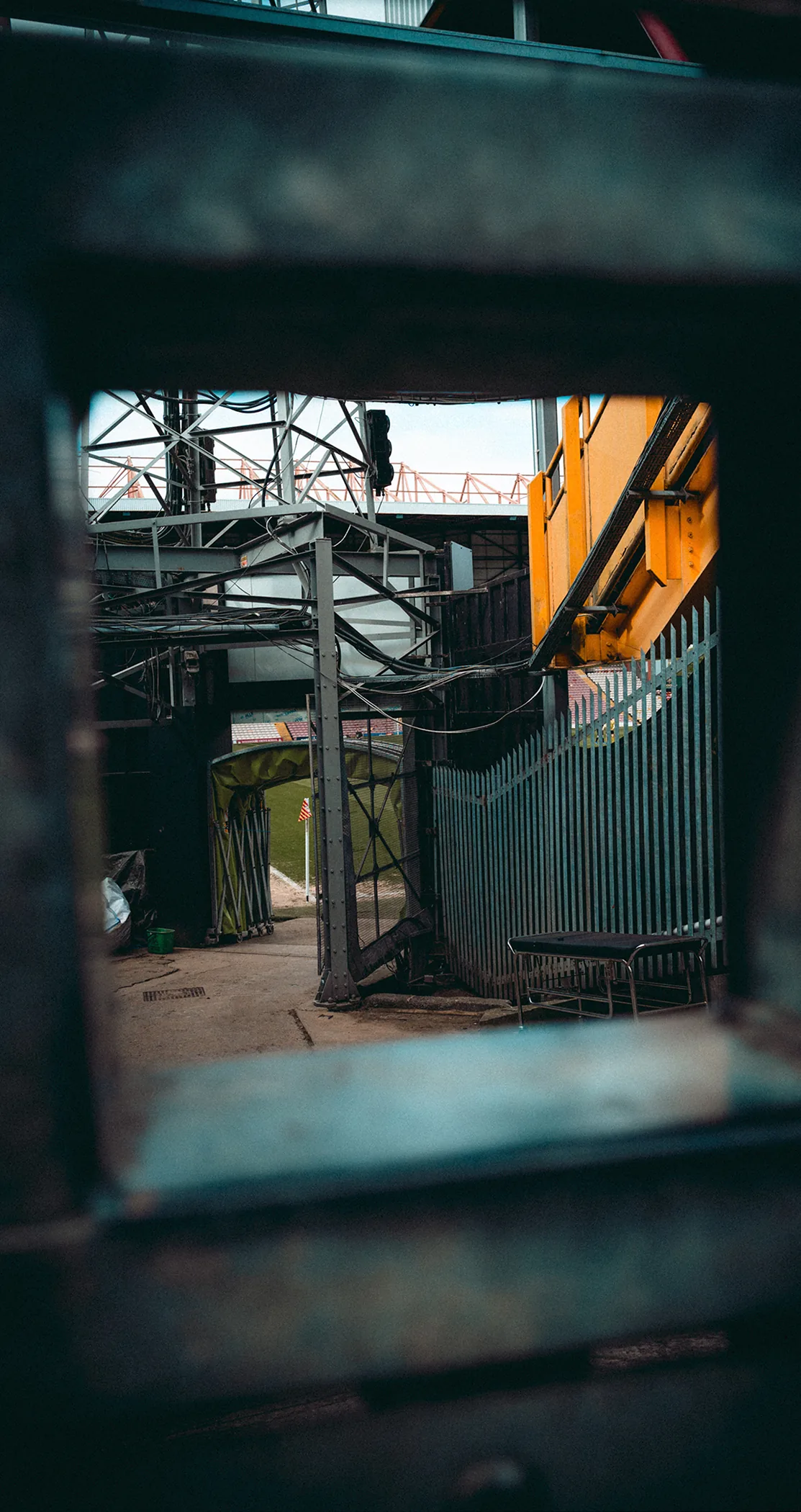 Industrial yard framed through a dark gateway, Leeds