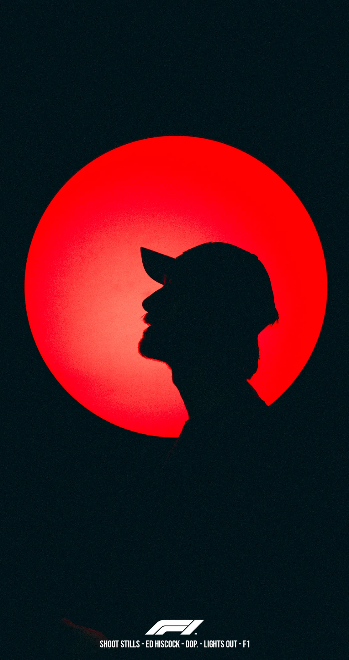 A driver's silhouette in a cap against a burning orange sun, Lights Out