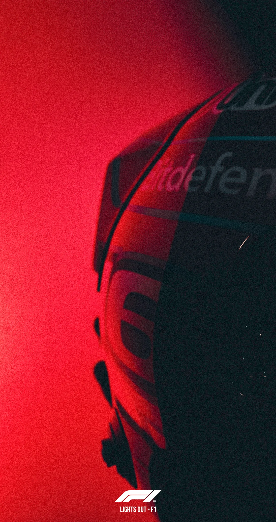 The edge of a race helmet lit deep orange against shadow, Lights Out