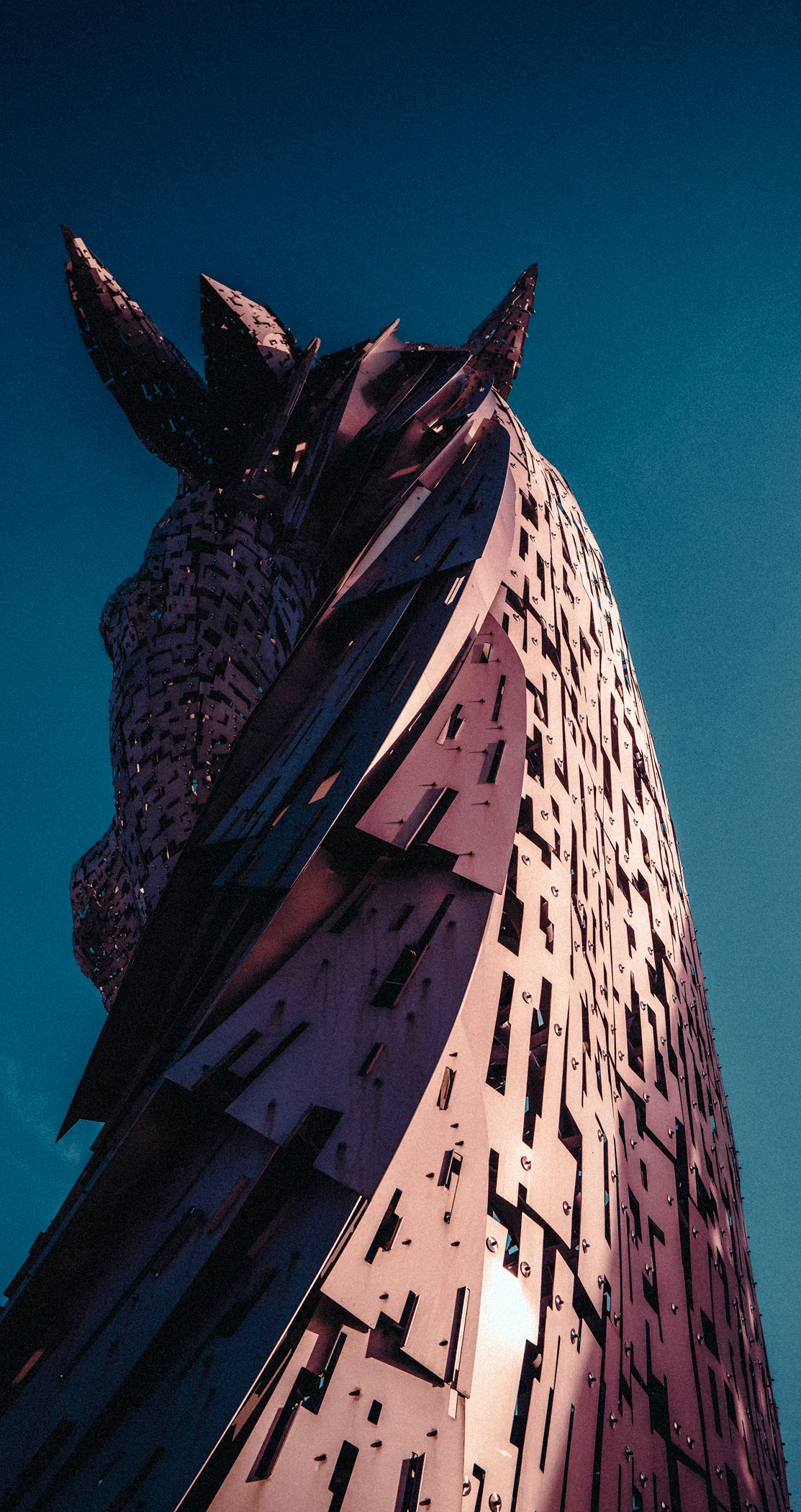The steel head of a Kelpie sculpture against a dark blue sky, Falkirk